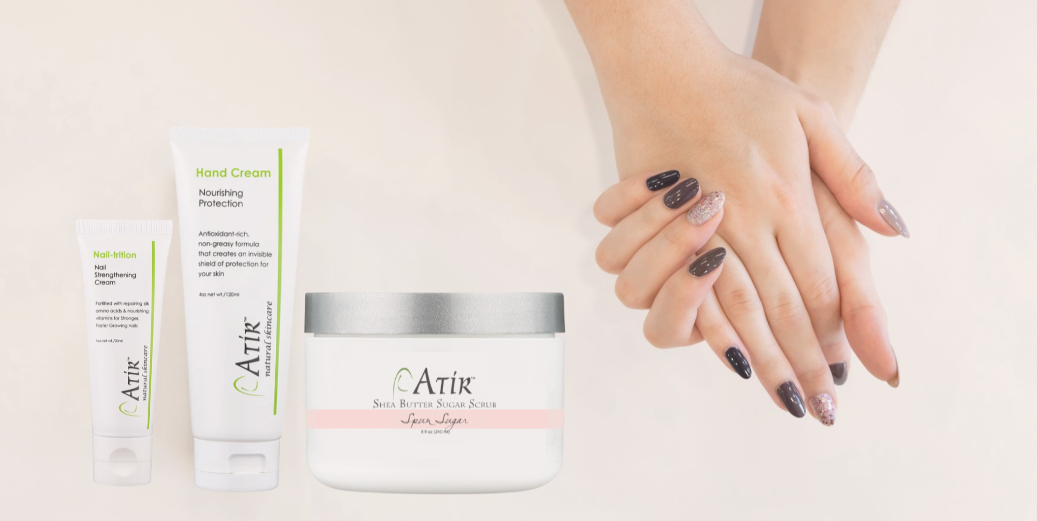 Woman's naturally manicured hands next to a selection of ATiR products