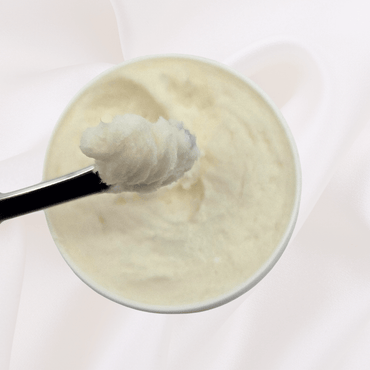 Close-up of ATiR PM Foot Repair Cream on spatula showing thick, nourishing texture