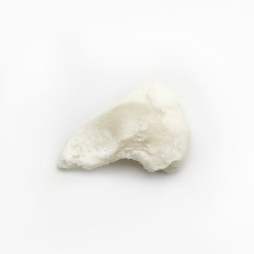 Swirl of thick, buttery PM Foot Repair cream on white background