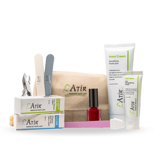ATiR Deluxe Natural Nail Care Kit with non-toxic nail polish, base and top coats, Nail-Trition cuticle cream, hand cream, and professional nail tools for complete at-home manicure care.