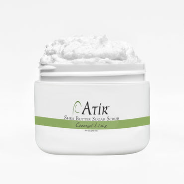 Open jar of Coconut Lime ATiR Shea Butter Sugar Scrub with whipped white scrub billowing to the top