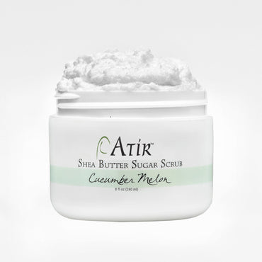 Open jar of Cucumber Melon ATiR Shea Butter Sugar Scrub with whipped white scrub billowing to the top