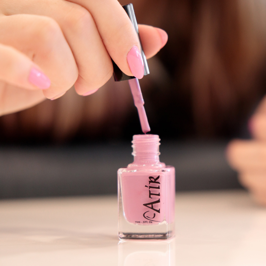 Woman preparing to apply ATiR non-toxic polish  for a natural nail manicure.